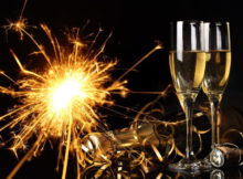 Glasses of champagne and fireworks